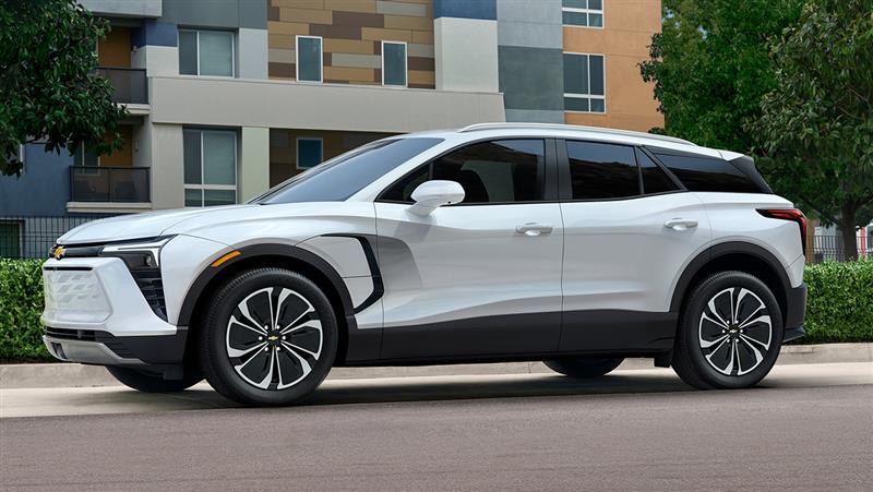 A 2026 Chevrolet Blazer EV, in side profile, parked in front of a business
