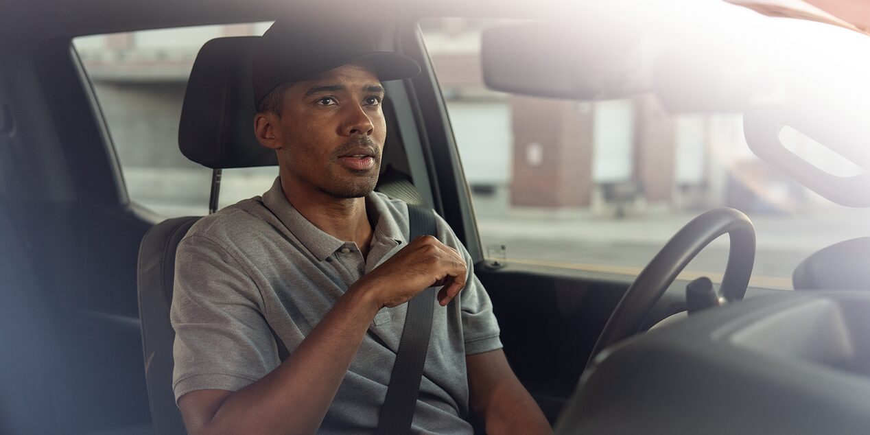 A construction worker sits in the driver seat of their Chevrolet Silverado.