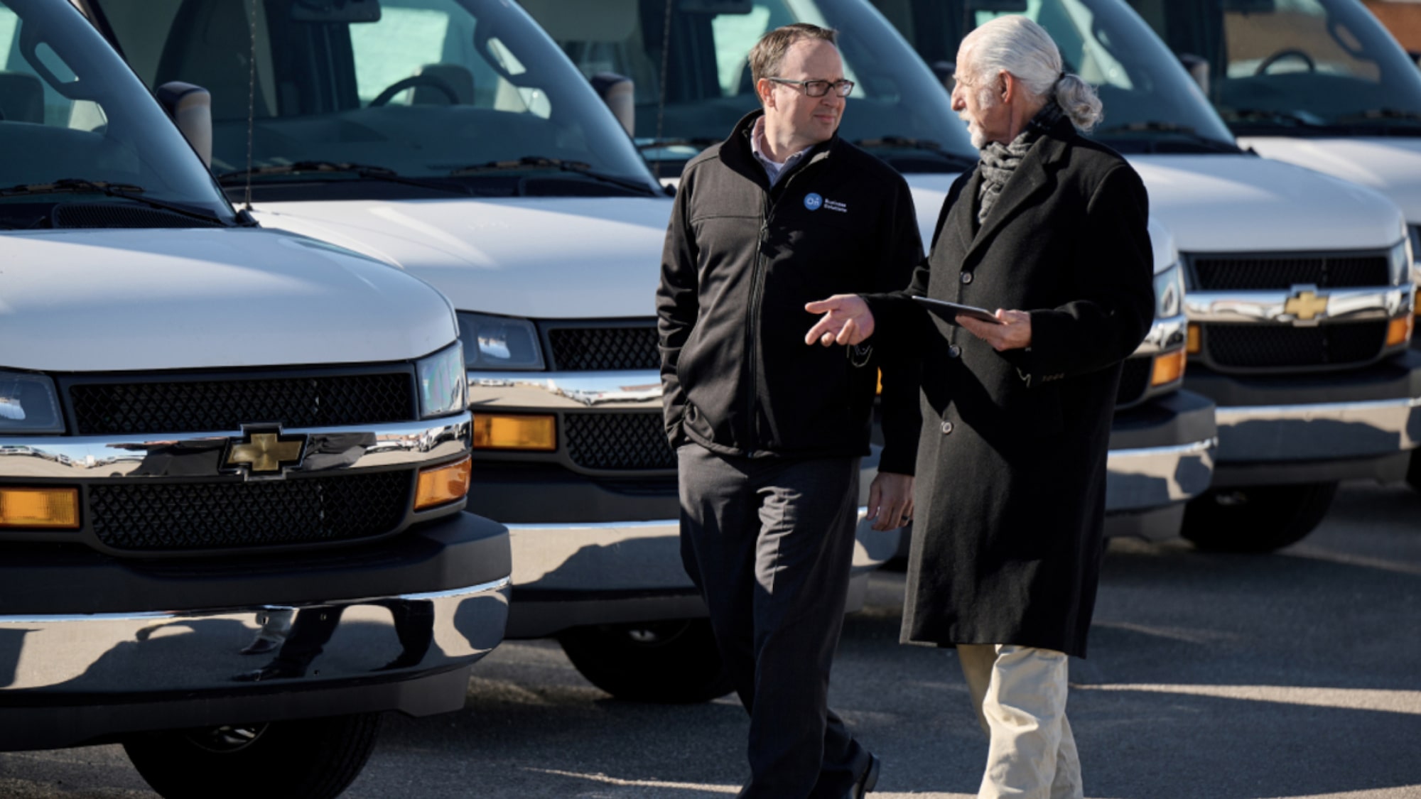 A GM Fleet specialist showing a customer a fleet of Cargo Express Vans
