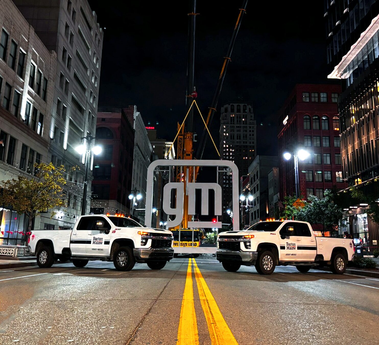 Two Barton Mallow branded Chevrolet Silverados parked downtown Detroit