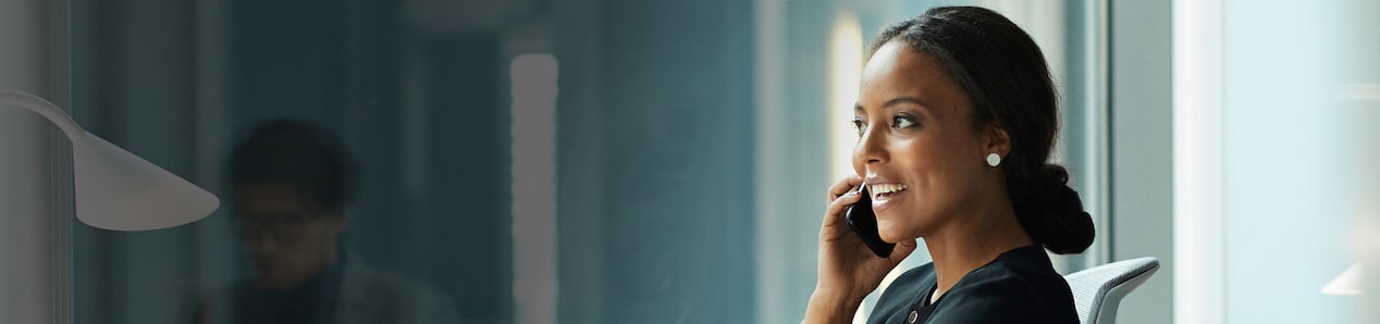 A woman speaking on the phone in her office