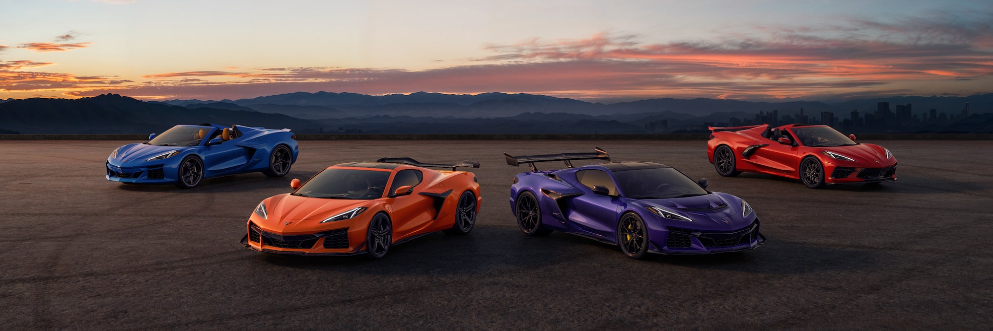 A lineup of Corvettes parked in the desert.