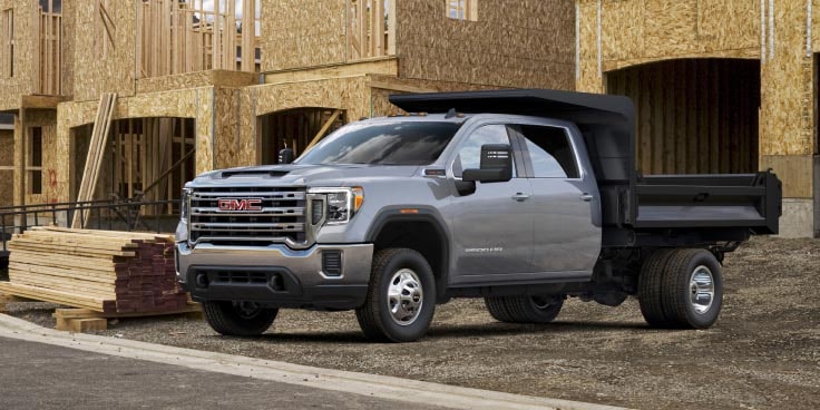 Side view of a GMC truck on a job site.