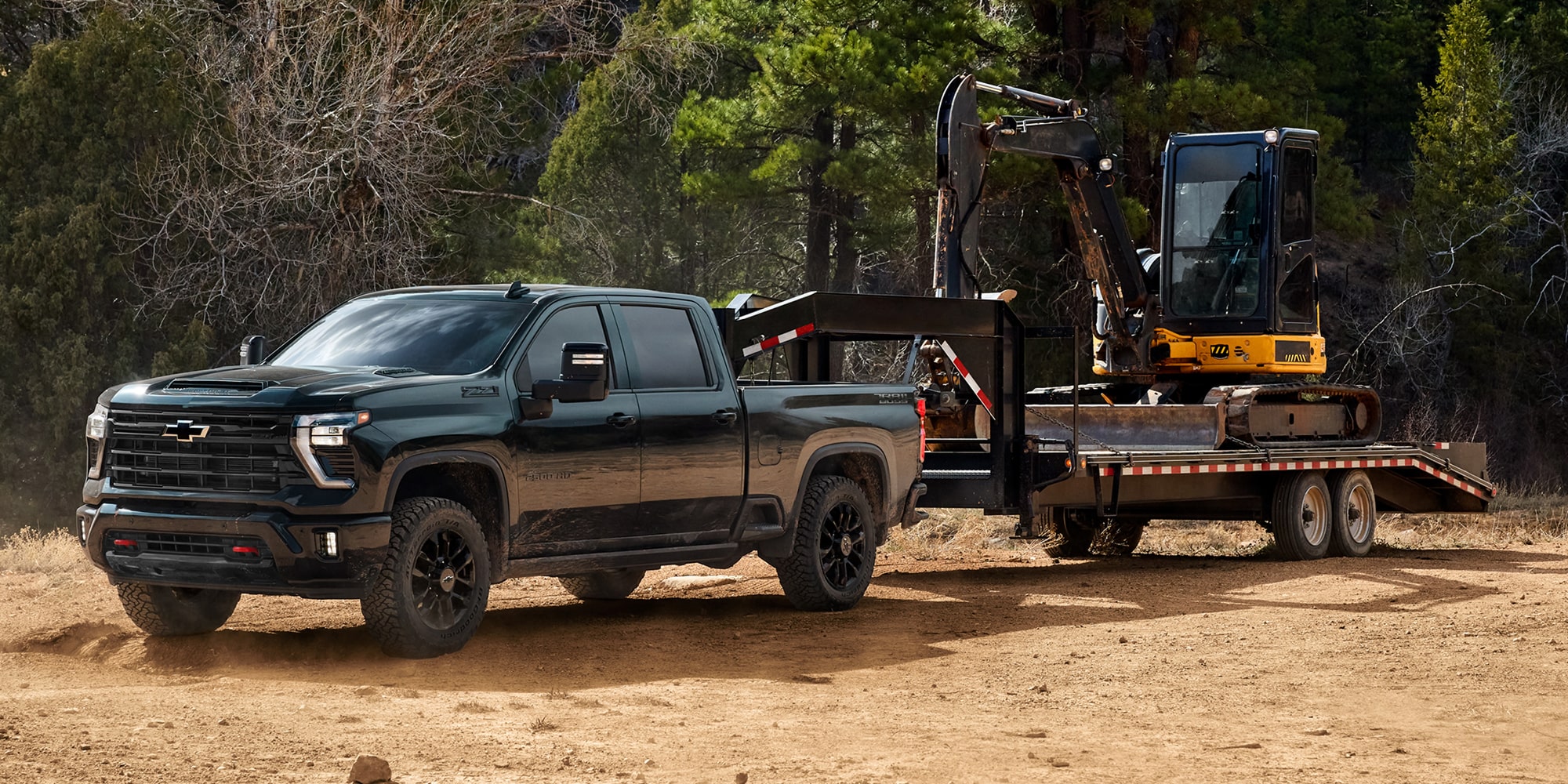 A Silverado HD pulling a loaded trailer.