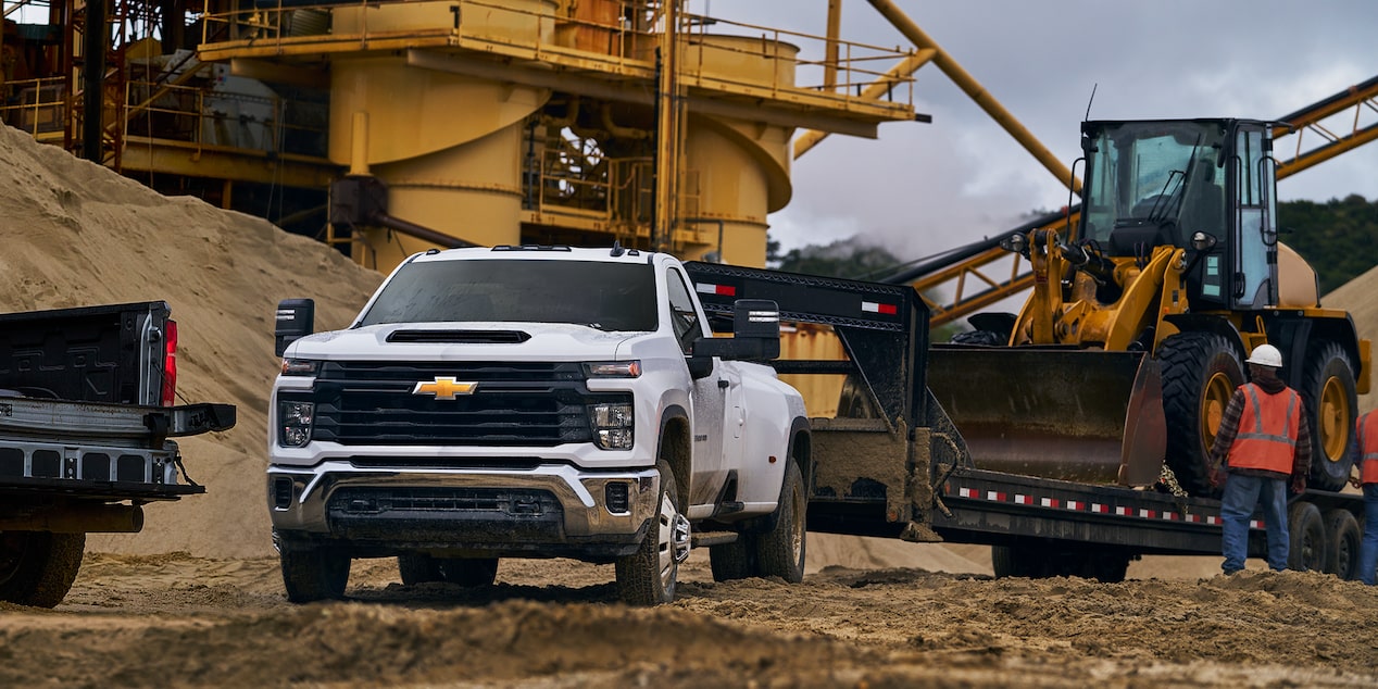 A Chevrolet Silverado HD pulling a loaded trailer
