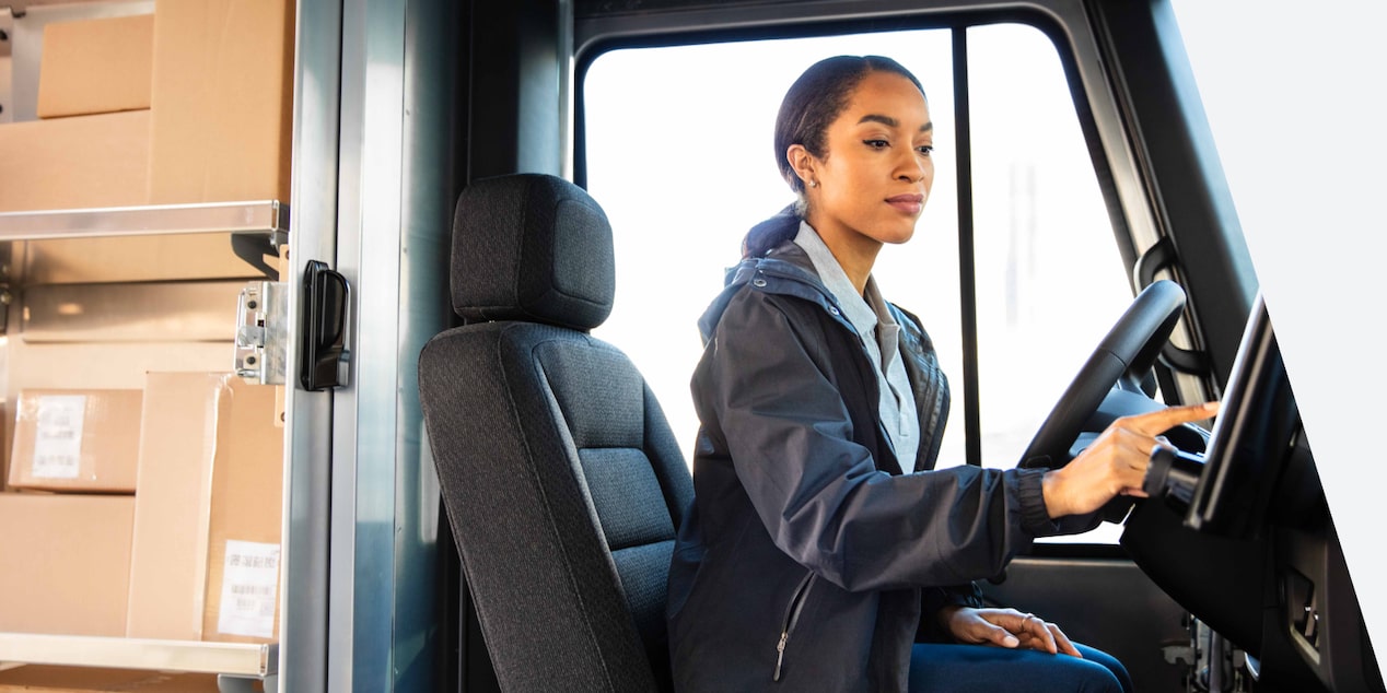A delivery driver sitting in the drivers seat of a 2025 BrightDrop