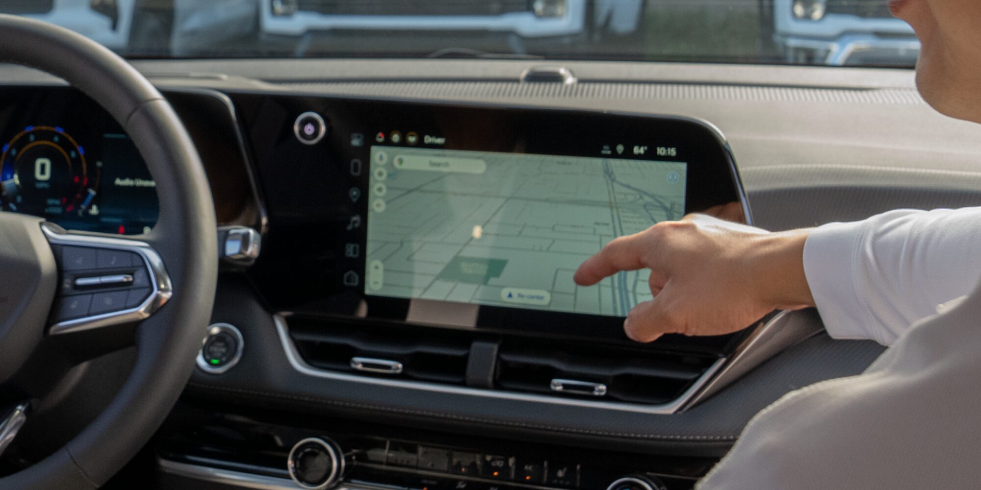 A passanger pointing at the Chevrolet Equinox infotainment system. 