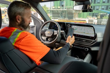 A construction worker sitting in the driver seat of their Chevrolet Silverado