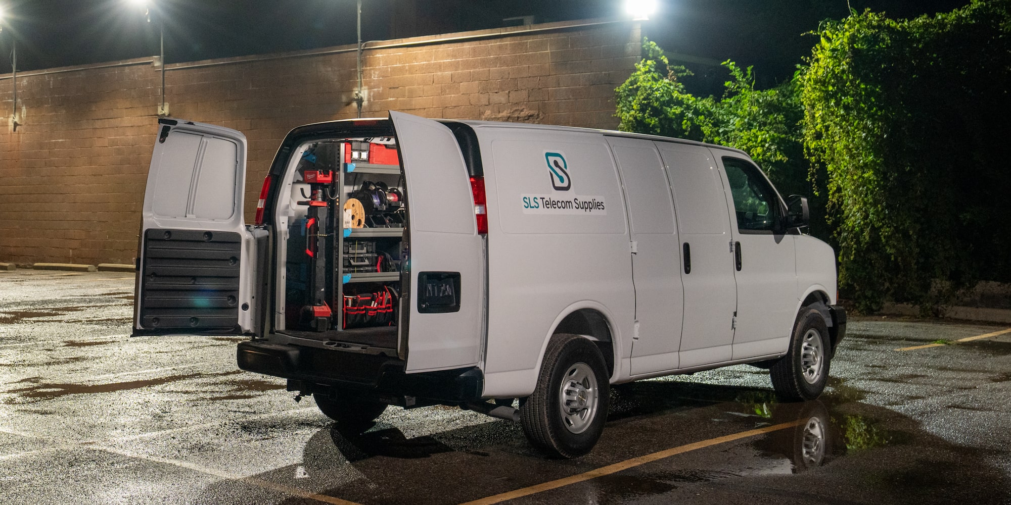 A 2026 Chevrolet Express Cargo Van with it's back open