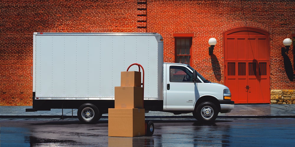 A Chevrolet Cargo Van parked in front of a building