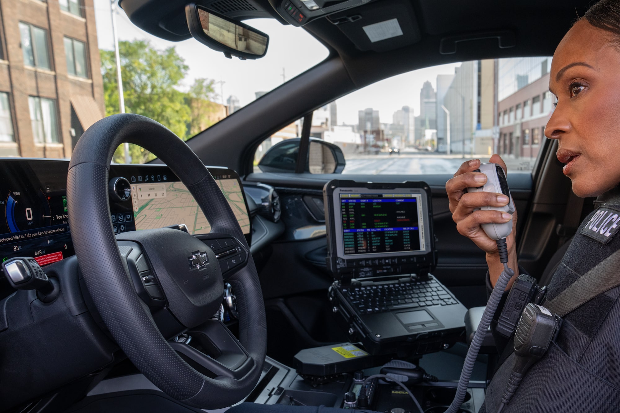 A police officer using their in vehicle radio in their Chevrolet PPV