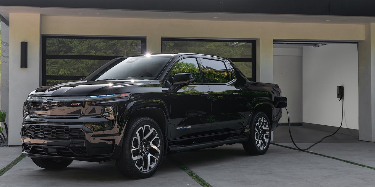 A Silverado EV PPV charging at a garage
