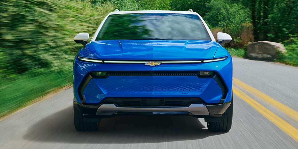 A front-view of a 2026 Chevrolet Equinox EV driving down a road