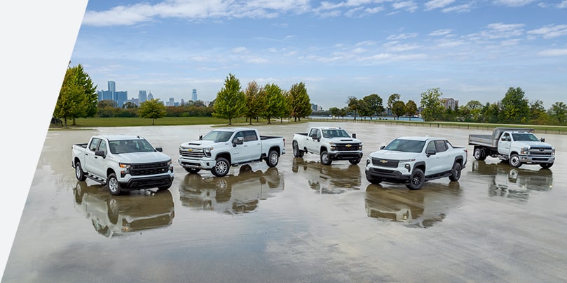 A group of five Chevrolet Silverados aranged in a parking lot, demonstrating a variety of trims and customizations