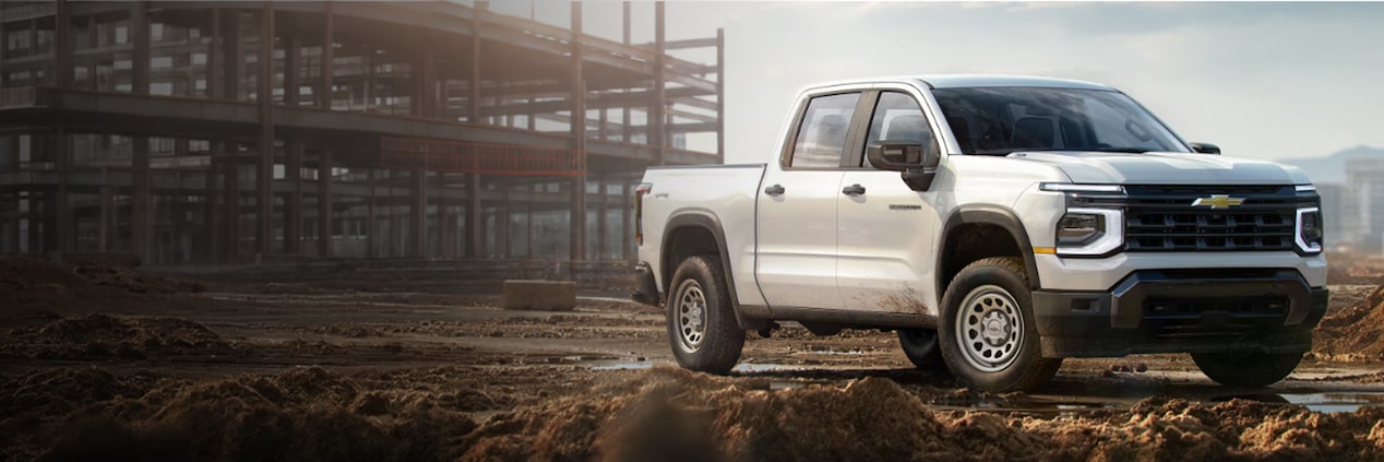 A white 2027 Chevrolet Silverado on a jobsite