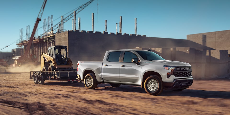 A 2026 Chevrolet Silverado pulling an equipment trailer