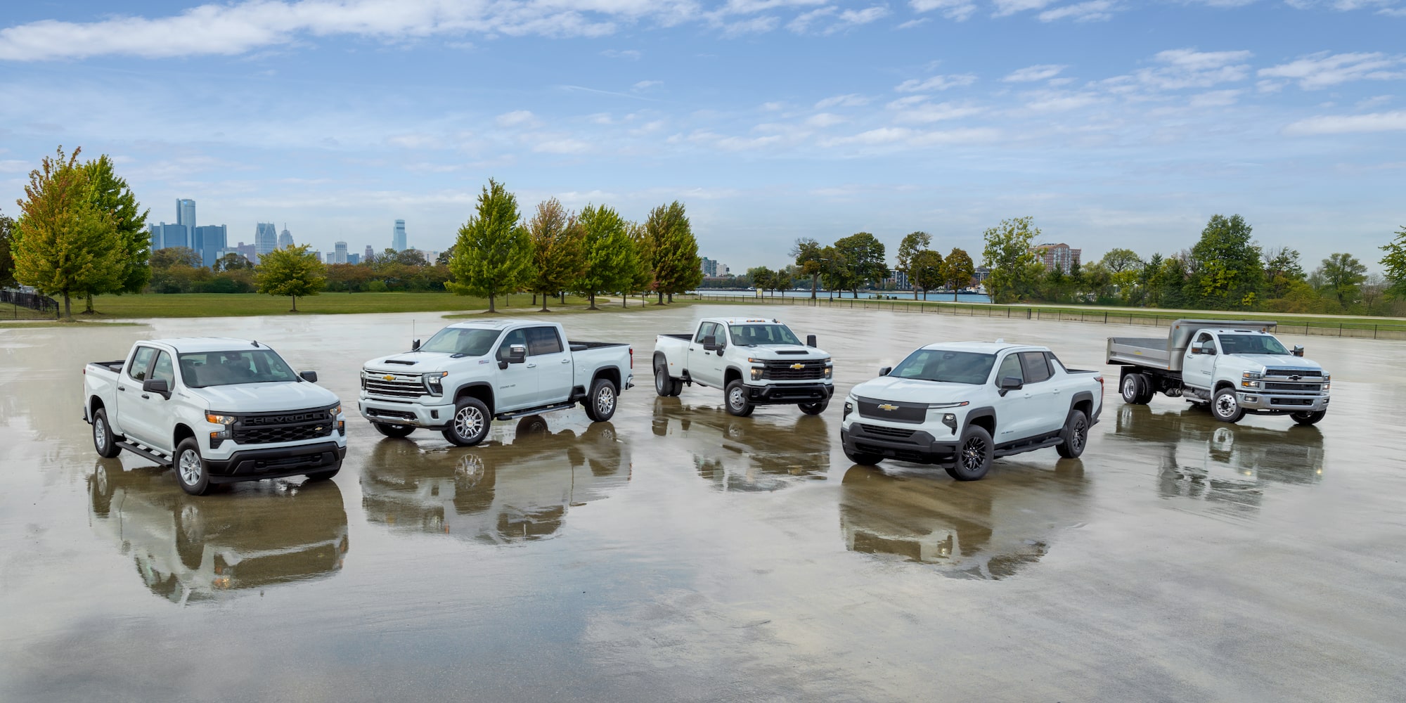 A group of five Chevrolet Silverados aranged in a parking lot, demonstrating a variety of trims and customizations 