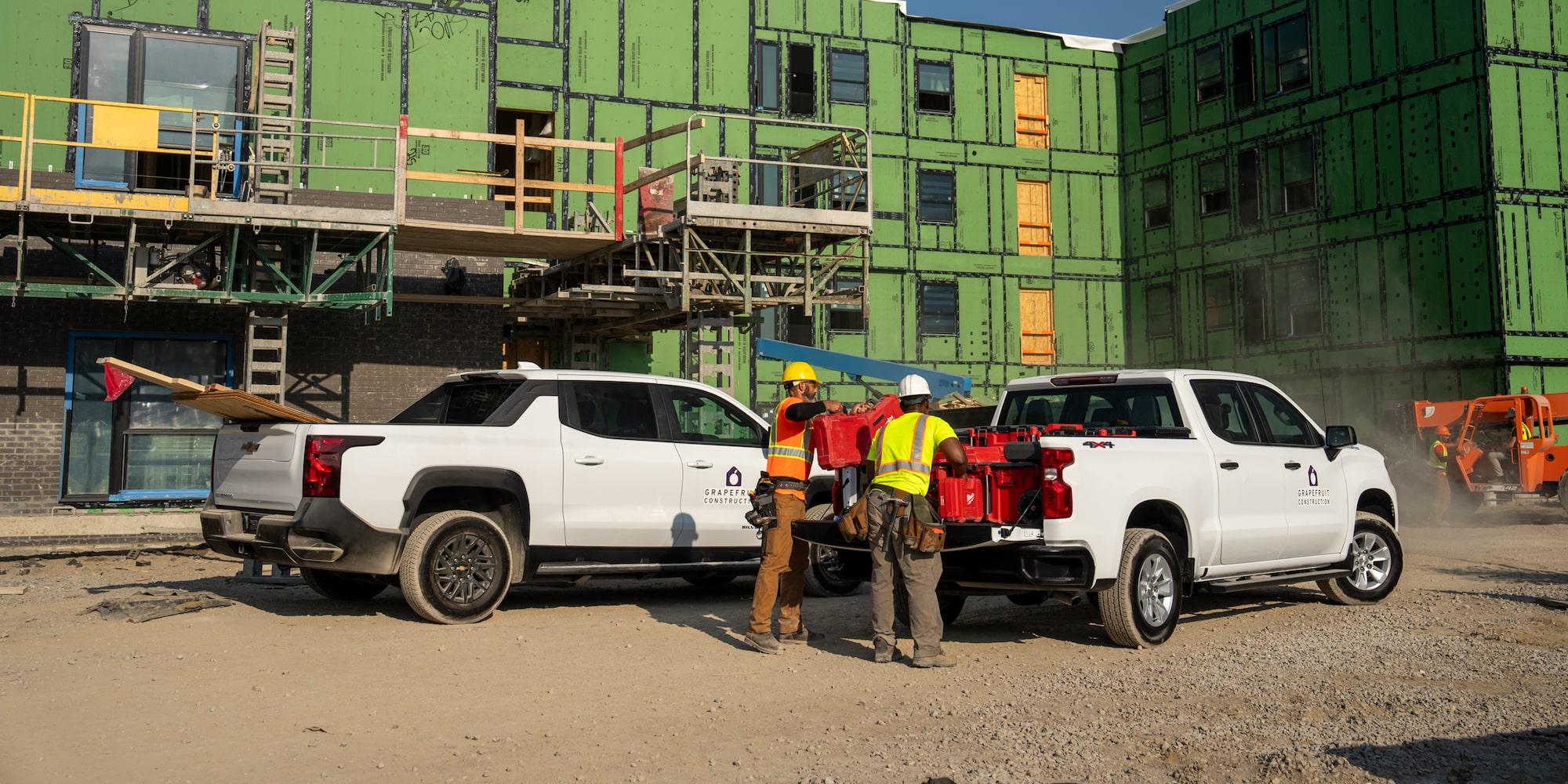 Two Chevrolet Silverados on a jobsite.