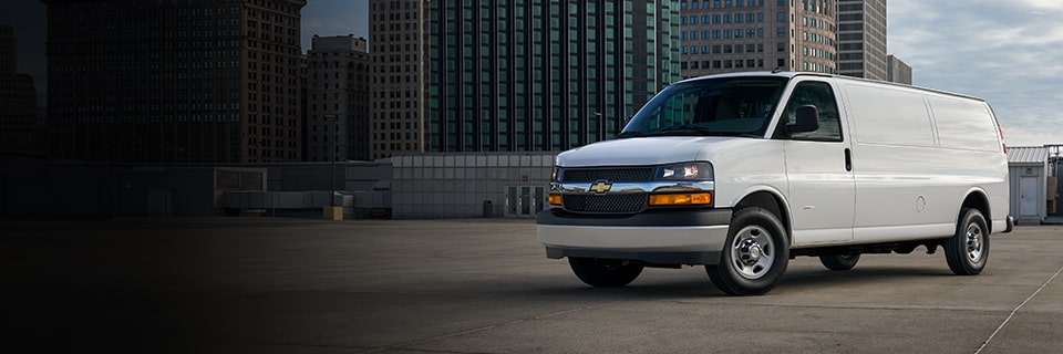 Chevrolet Express Cargo Work Van in three-quarter view on the roof of a parking garage