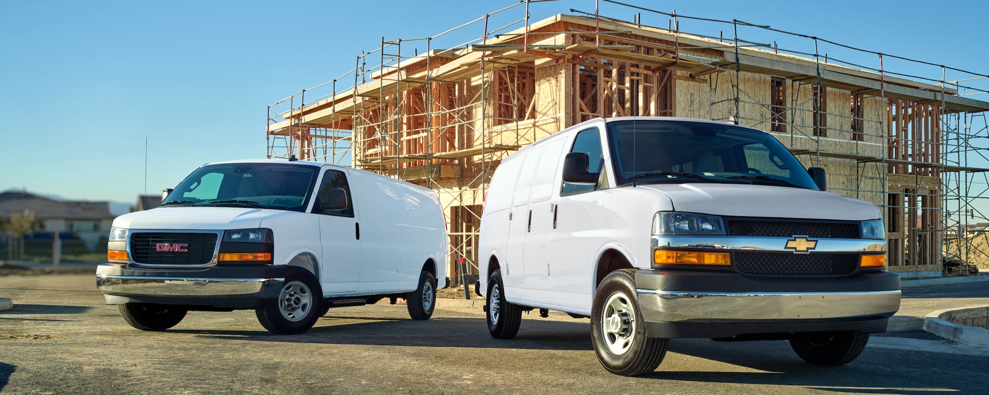 A Chevrolet Express Cargo Work Van and a GMC Savannah Cargo Van