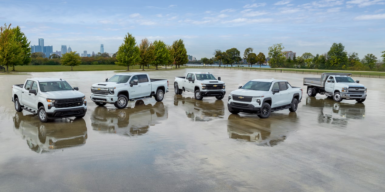 A group of five Chevrolet Silverados aranged in a parking lot, demonstrating a variety of trims and customizations