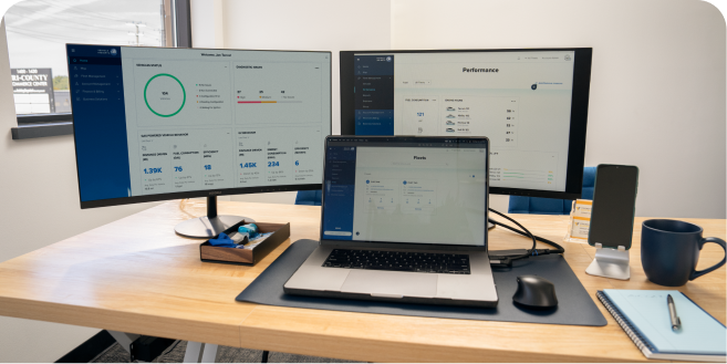 OnStar One Fleet displayed on two monitors and a laptop