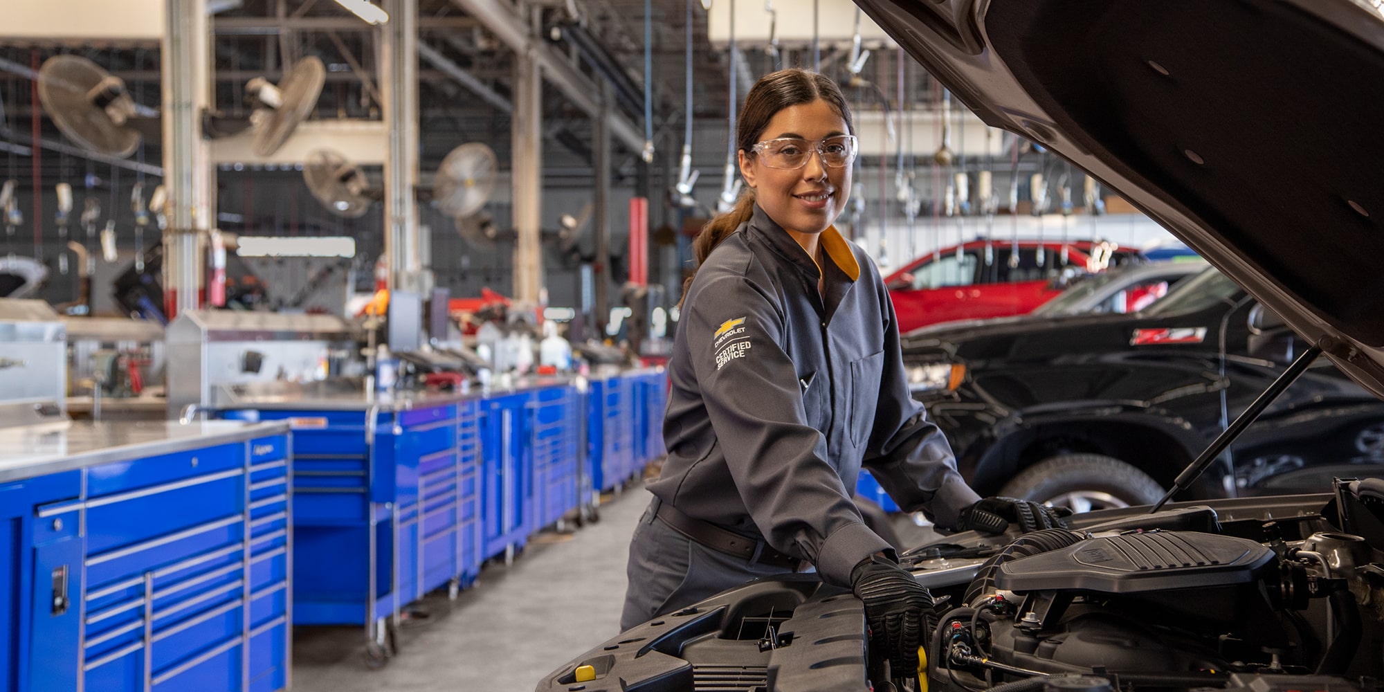 A GM fleet service technician working on a fleet vehicle.