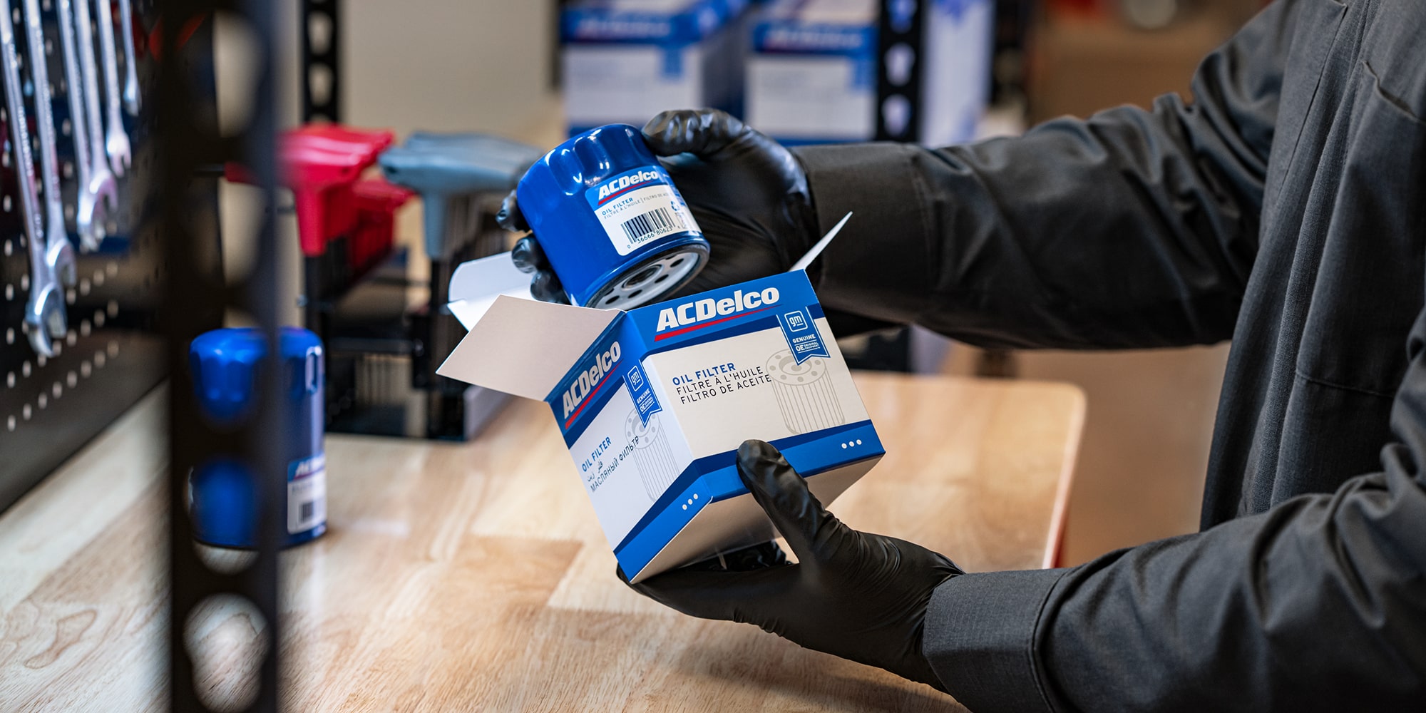A service technician holding an AC Delco part box.
