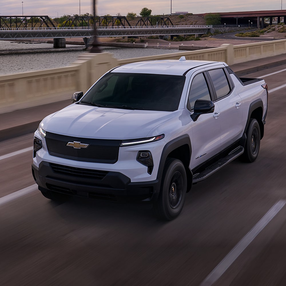 A Sliverado EV driving down a highway