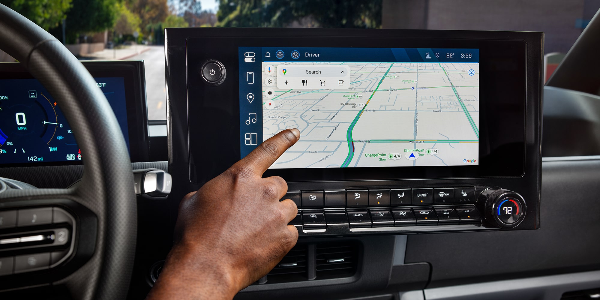A delivery driver programming route navigation in the cabin of a BrightDrop Zevo delivery vehicle.