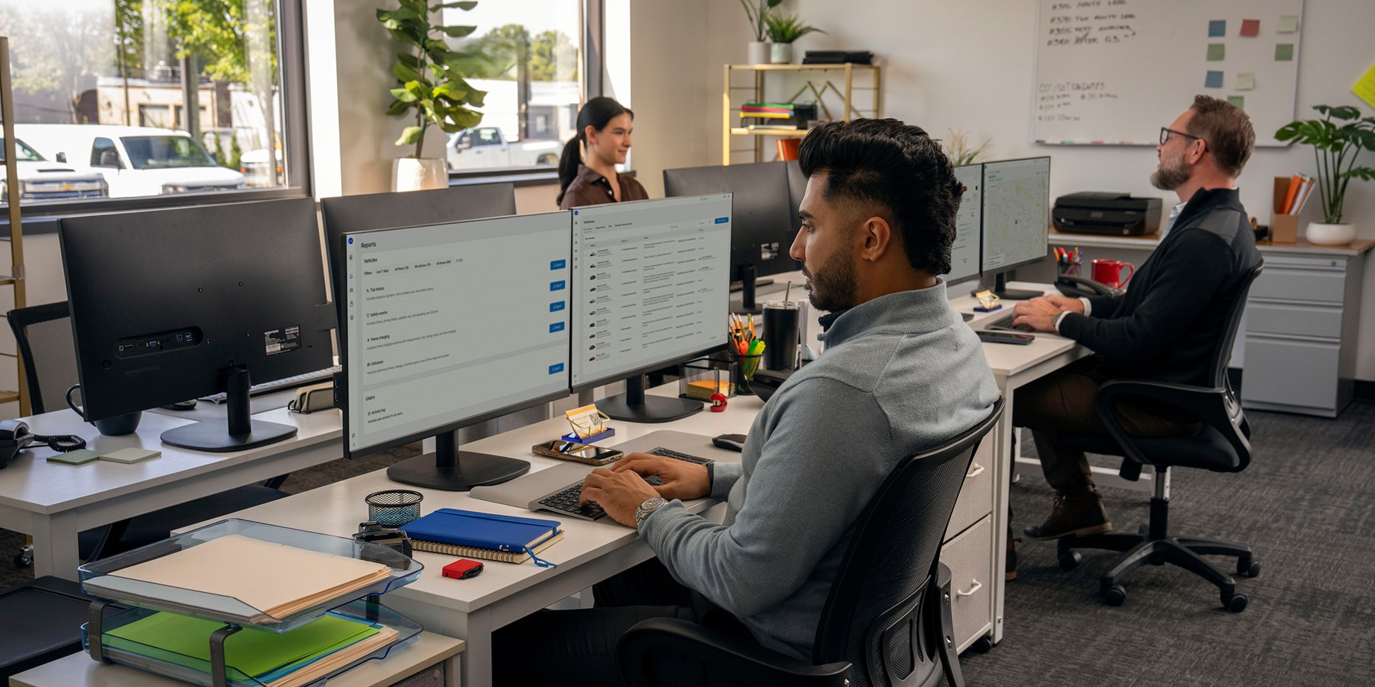 Someone working from their desktop sitting at a desk in an office setting.