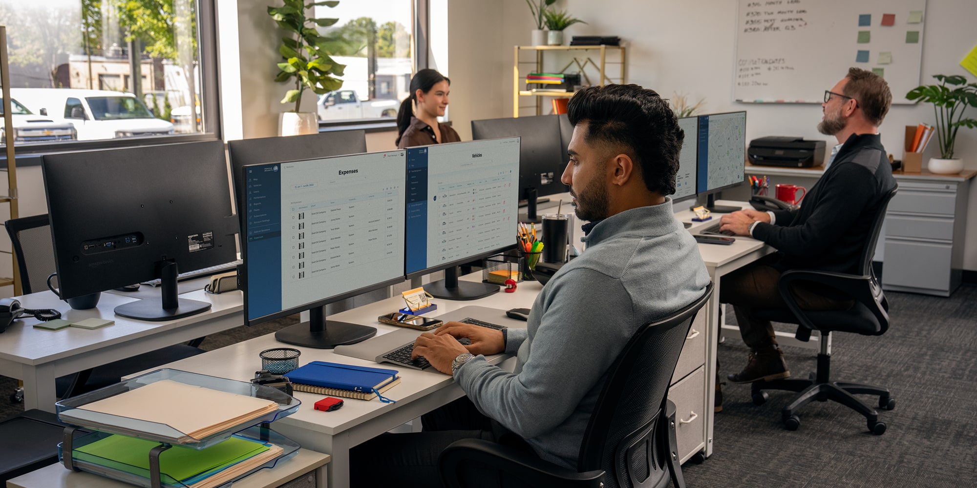 Someone working from their desktop sitting at a desk in an office setting. 