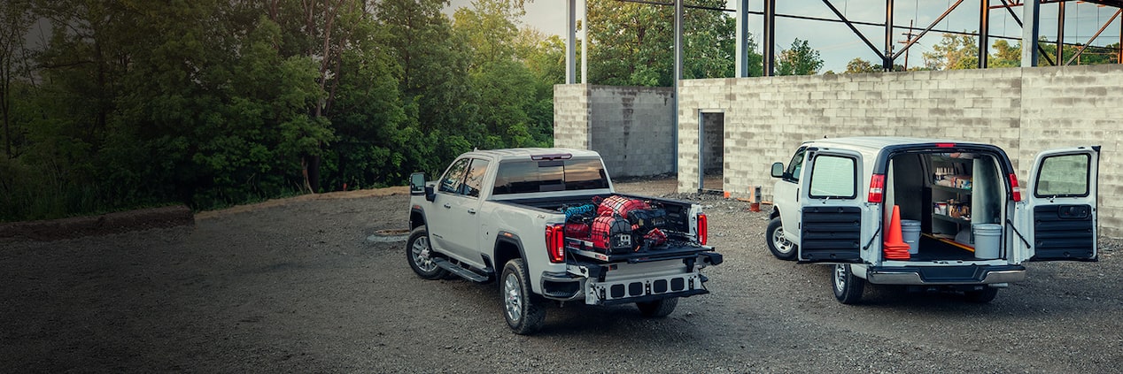 Two GM trucks on a job site