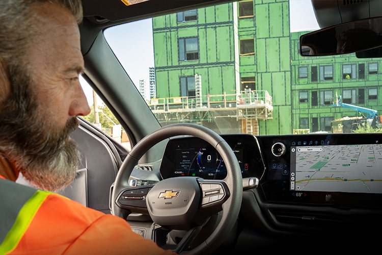 A close up of a driver using voice commands in their Silverado EV