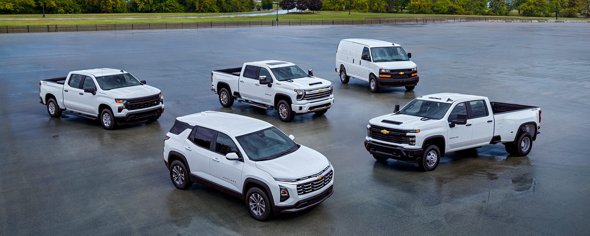A fleet of white Chevrolet vehicles.