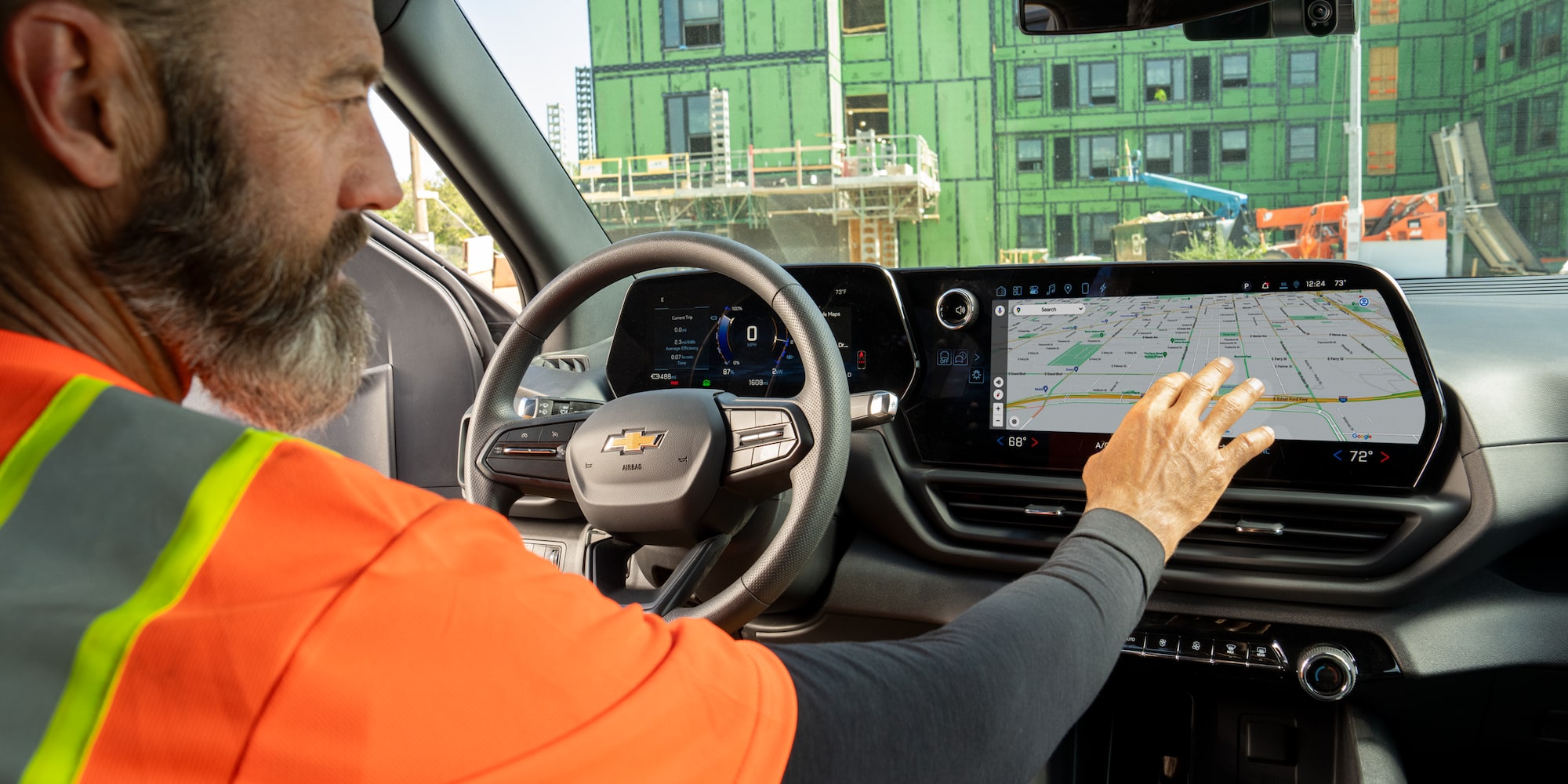 A driver using the infotainment system in his Chevrolet Silverado. 