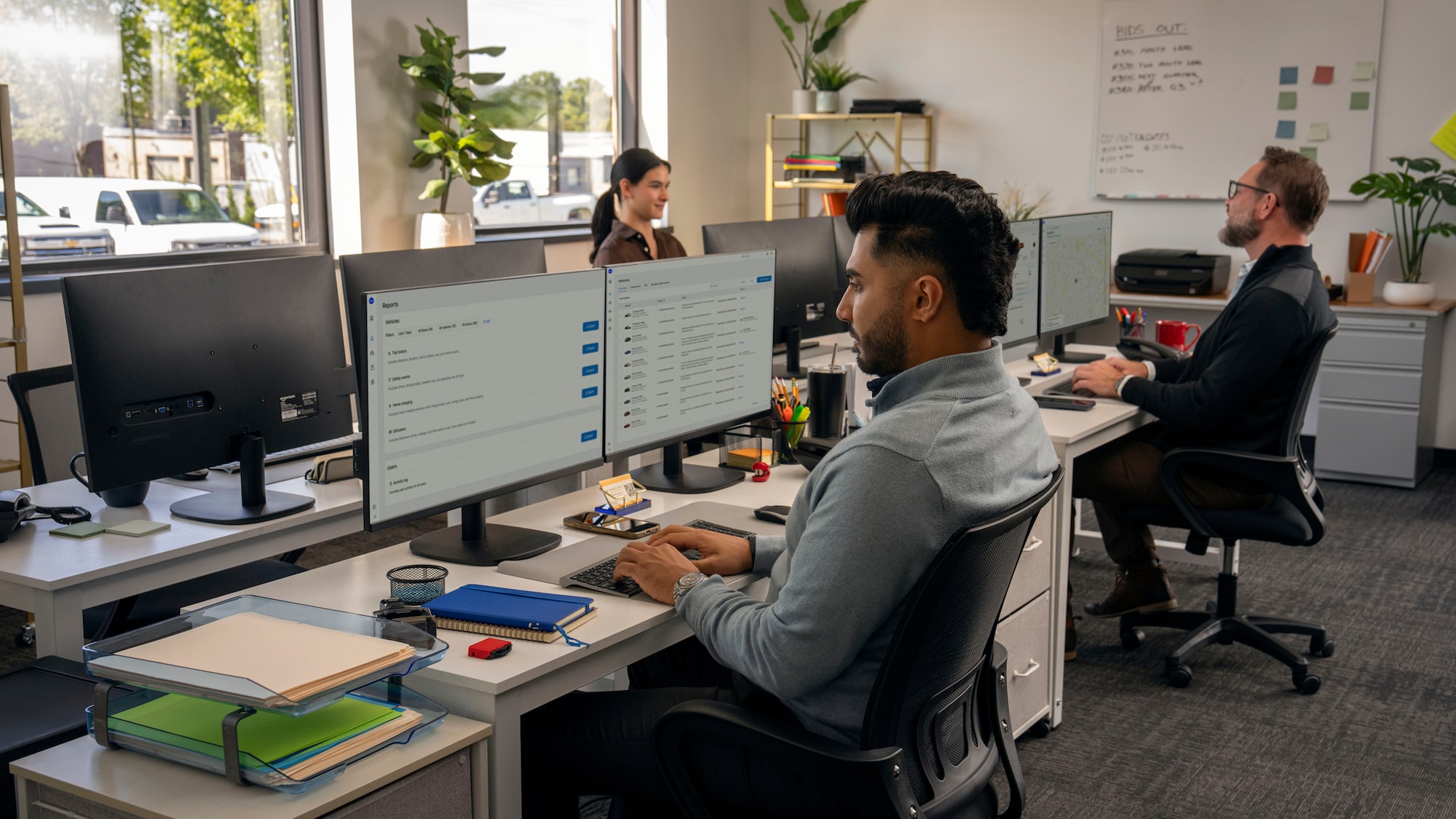 Three office workers using GM One Fleet