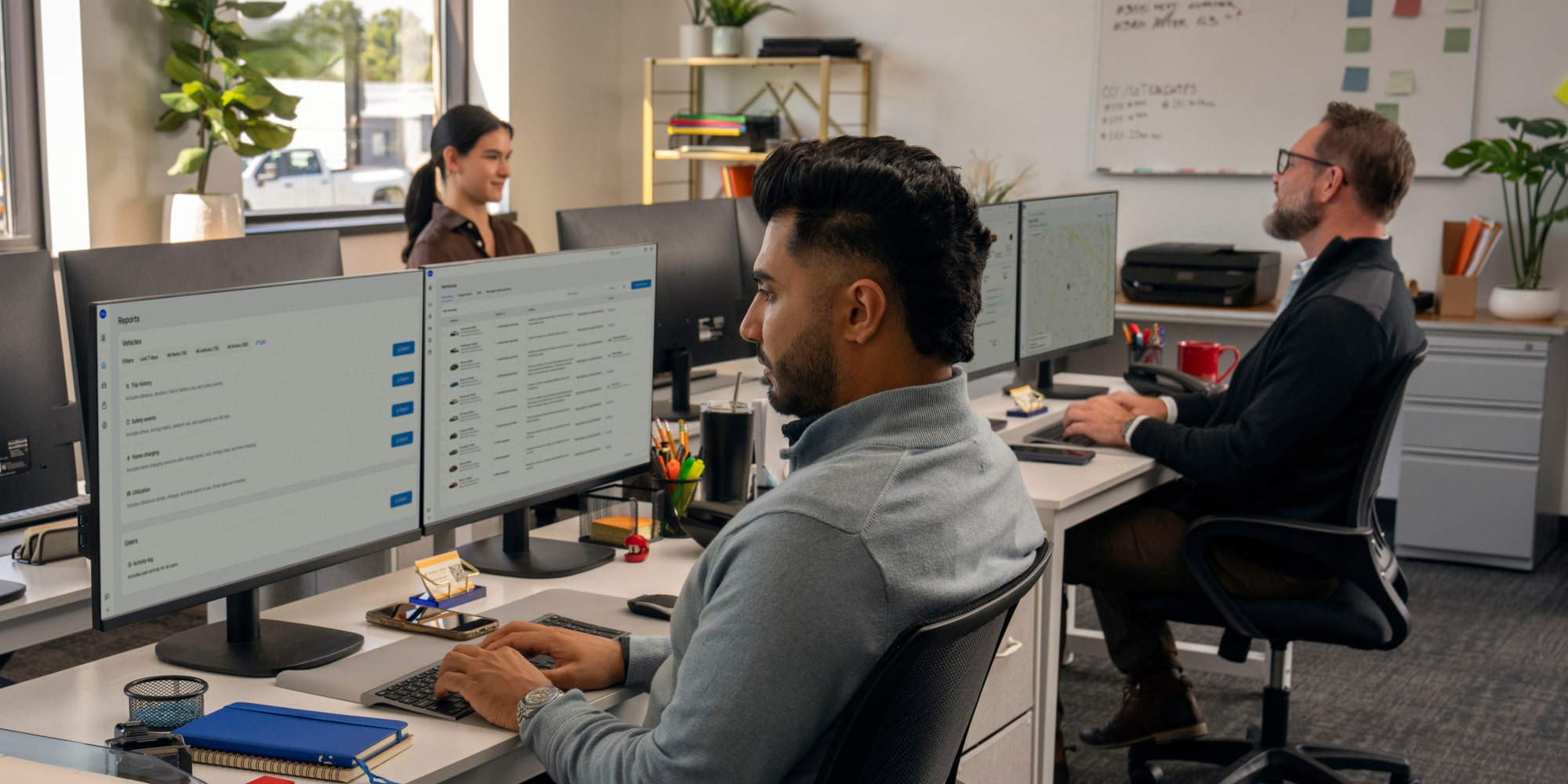 three office workers using GM Fleet telematics.