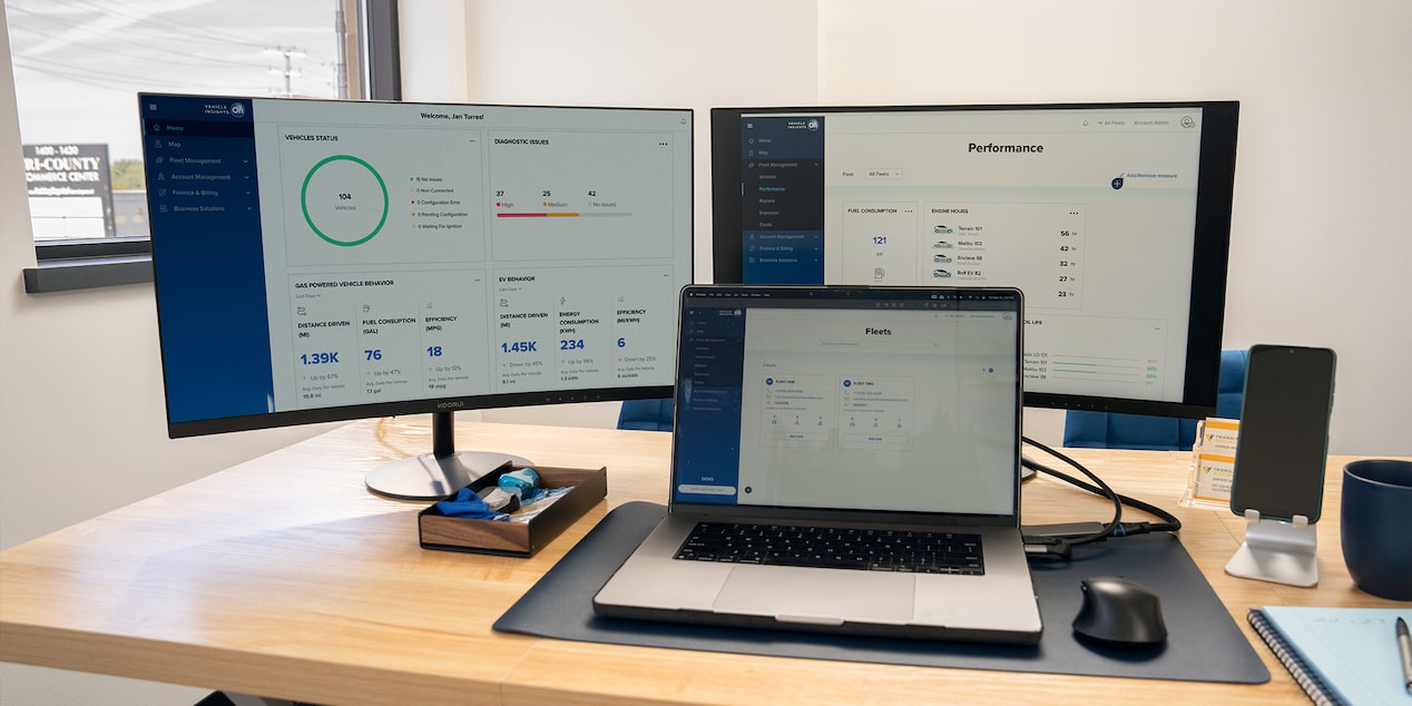 OnStar One Fleet on two monitors and a laptop.