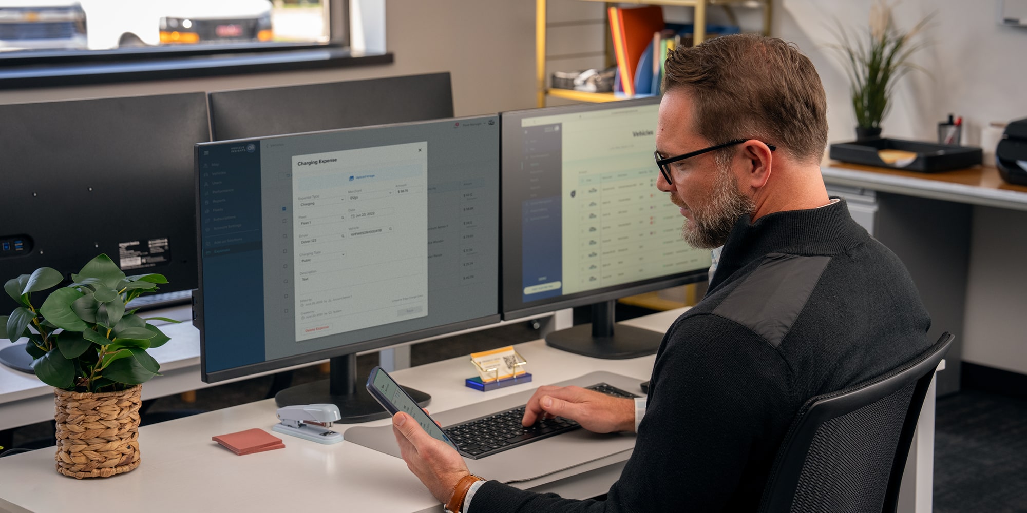An office worker using teh GM Fleet OnStar One Fleet app