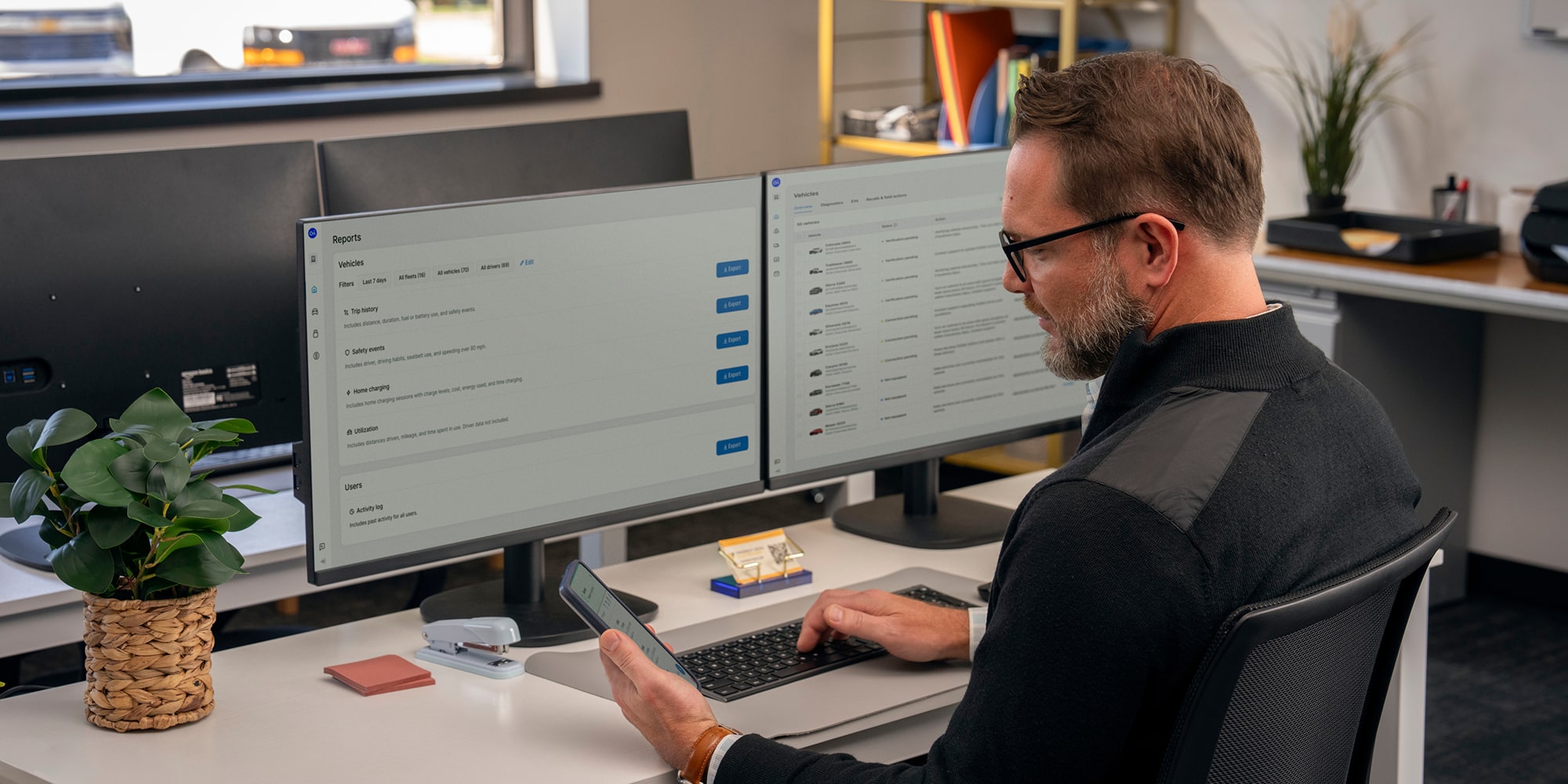 An office worker using teh GM Fleet OnStar One Fleet app