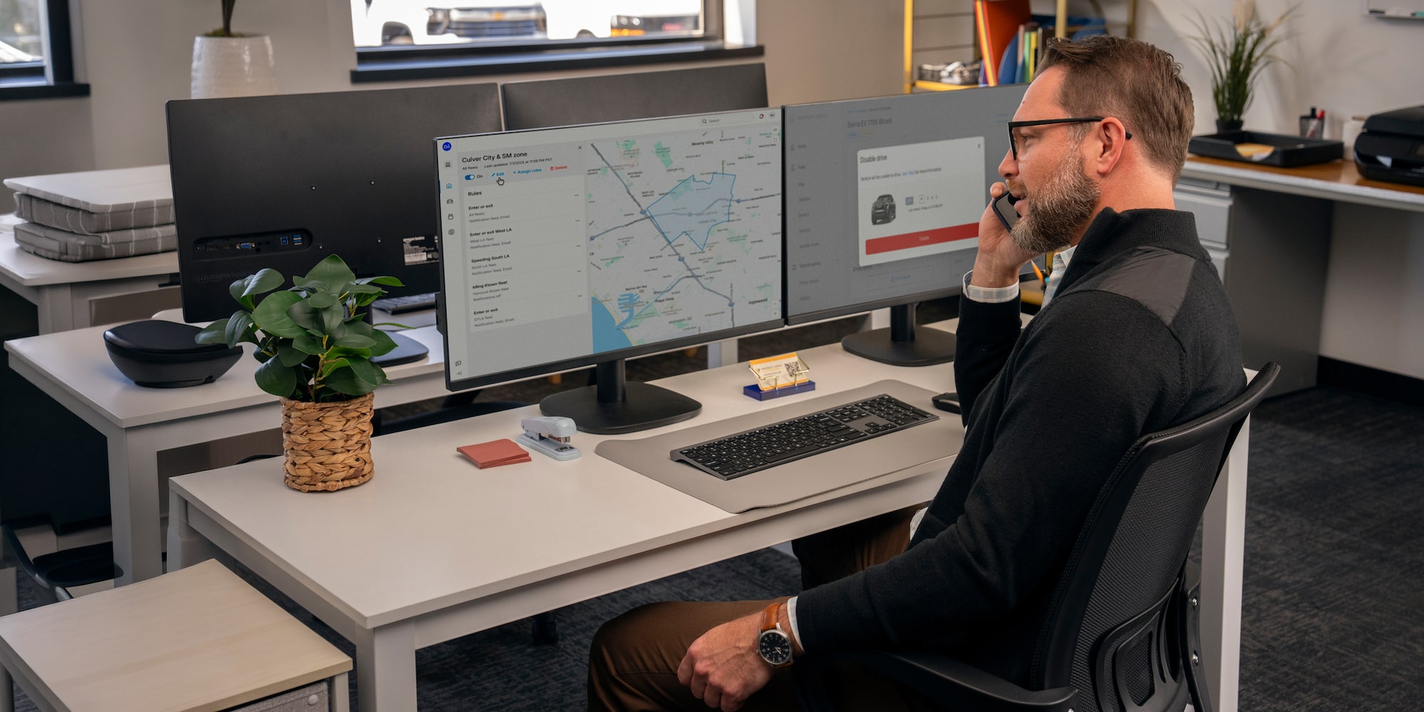An office worker on the phone while using One Fleet Intelligence