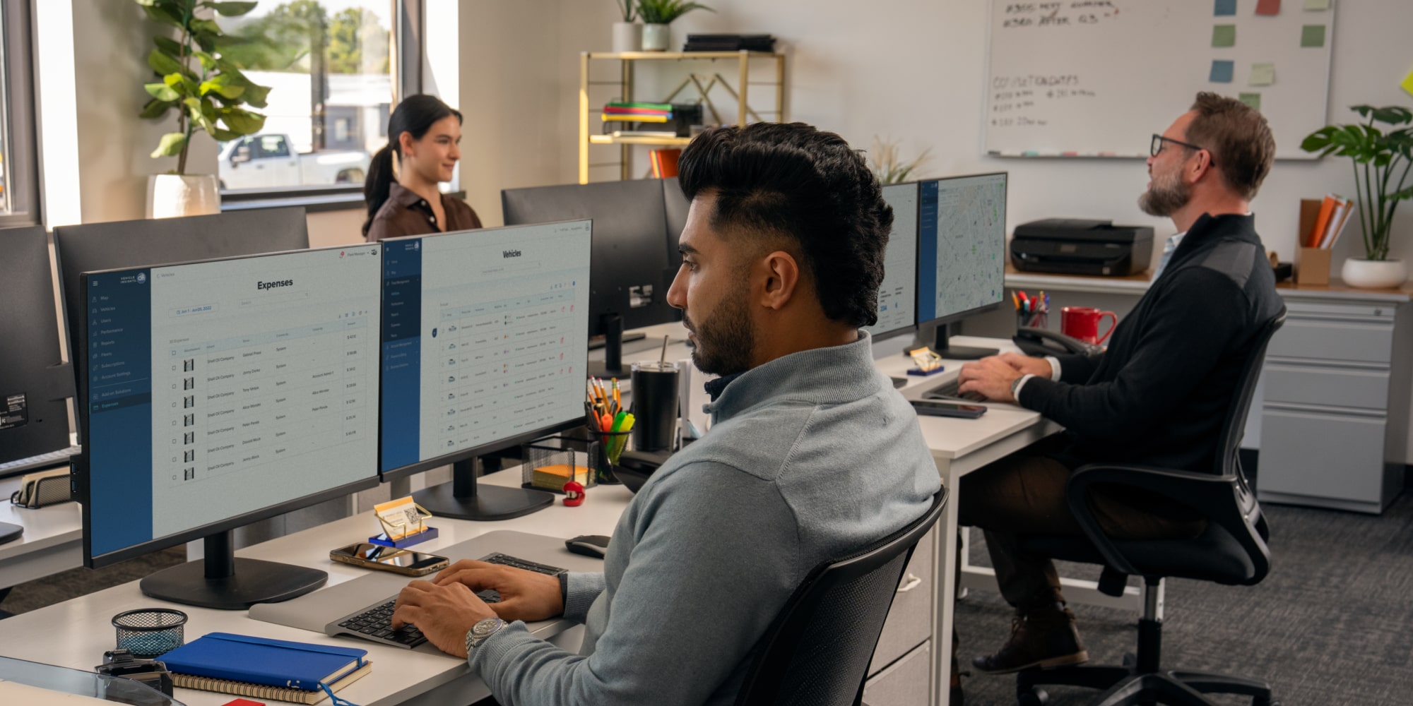 three office workers using GM Fleet telematics.