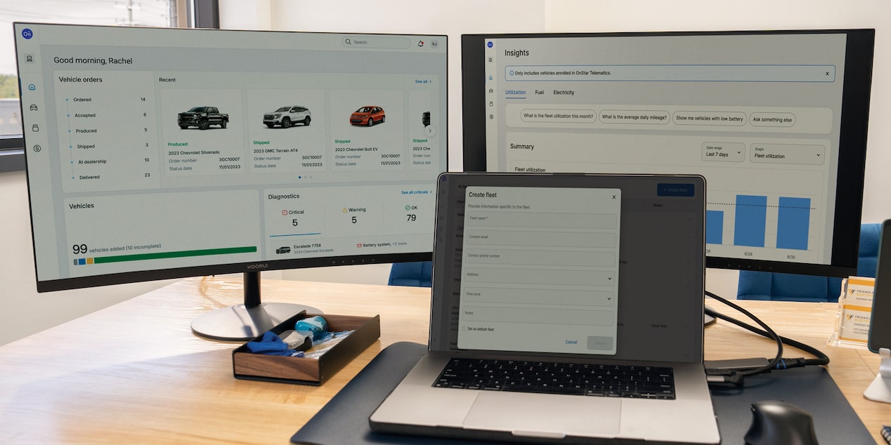 GM Fleet OnStar Fleet Intelligence on two monitors and a laptop. 