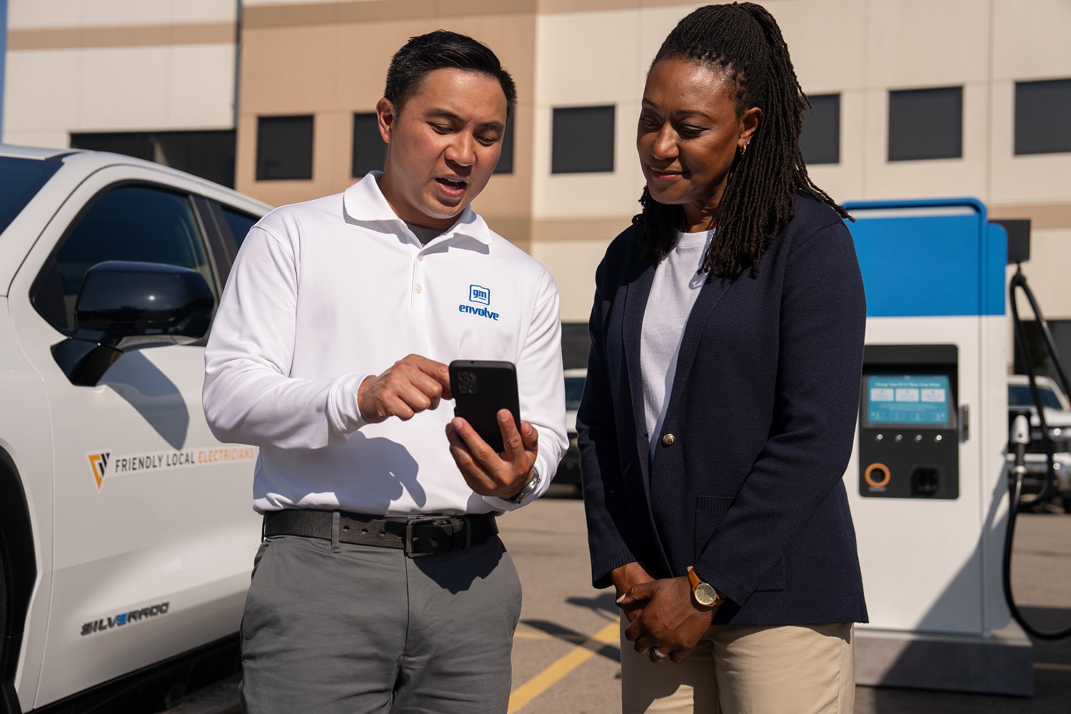A GM Fleet worker demostrating the OnStar EV Battery State of Charge feature on his phone. 