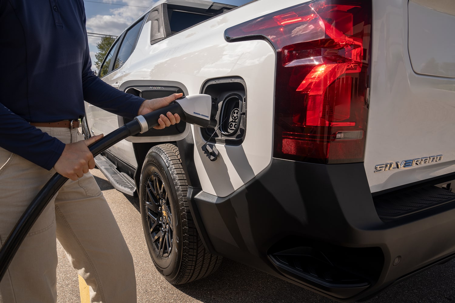 An EV Charger being plugged into a Silverado EV.