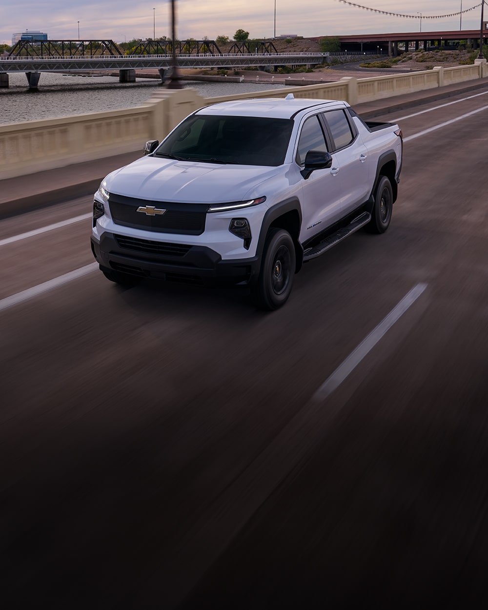 A Sliverado EV driving down a highway