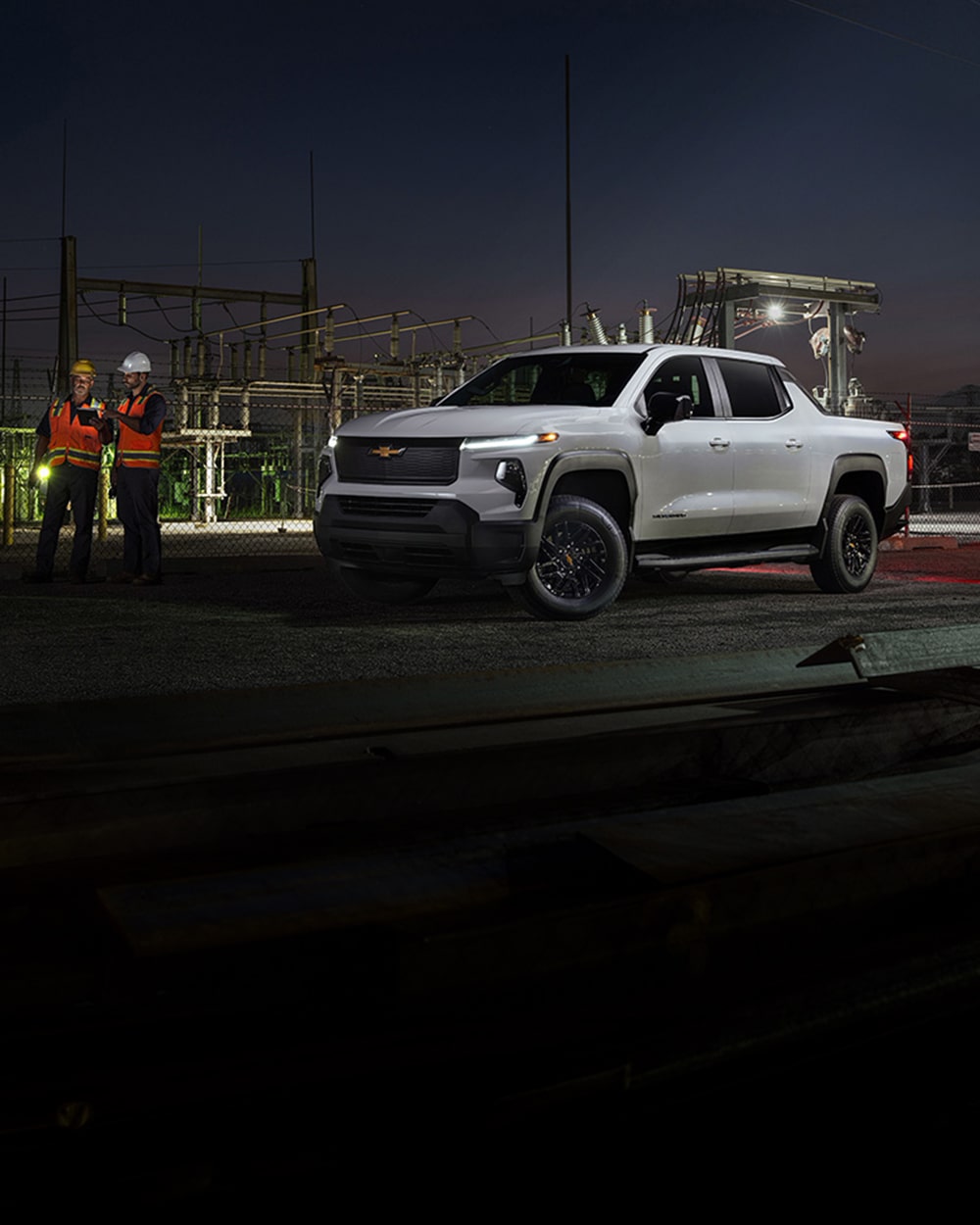 A Silverado EV parked at a jobsite at night.