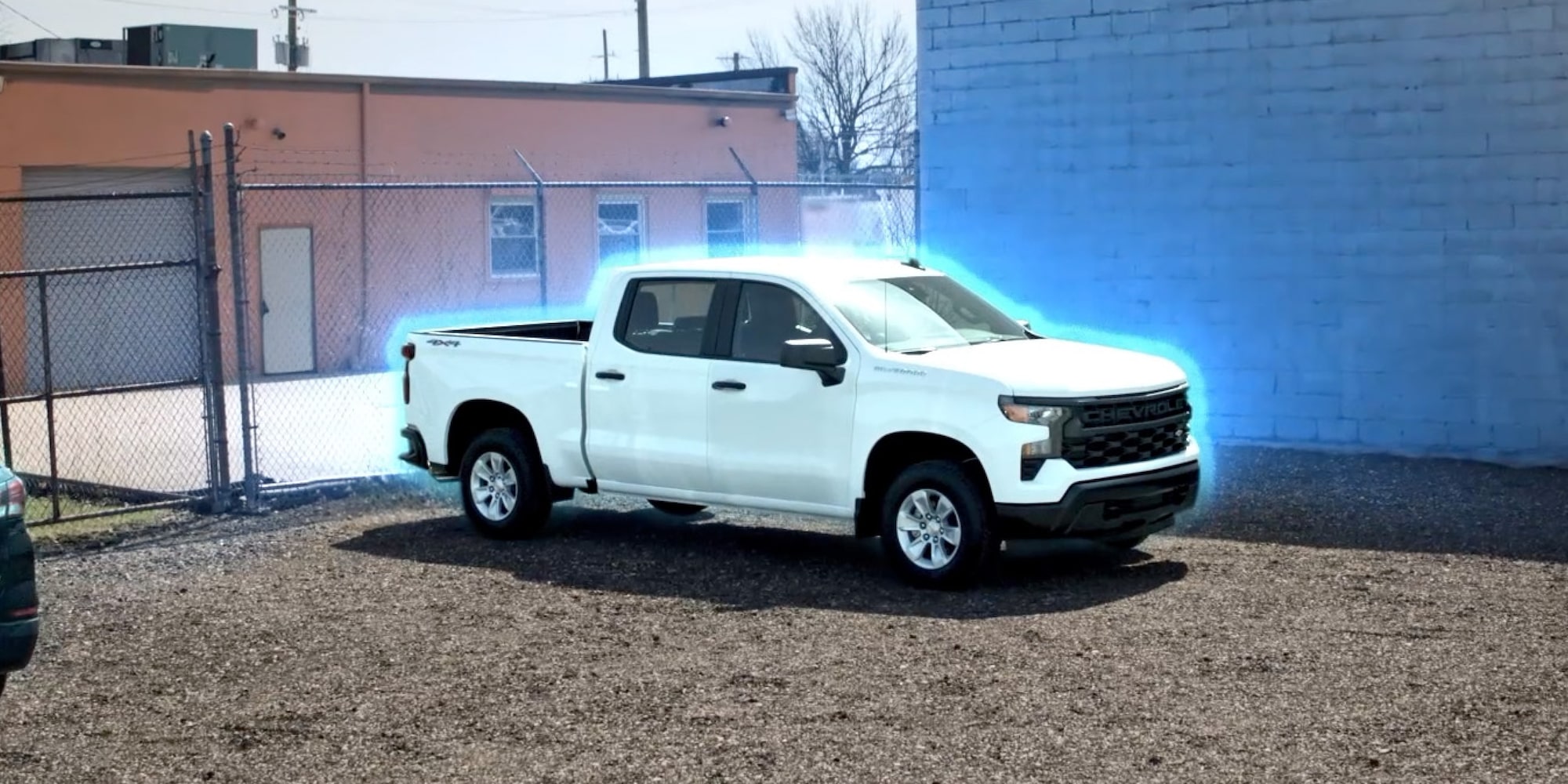 A white Chevrolet Silverado with a blue glow.