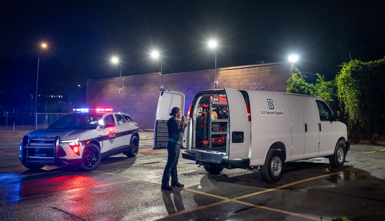 A police officer looking the back of a van